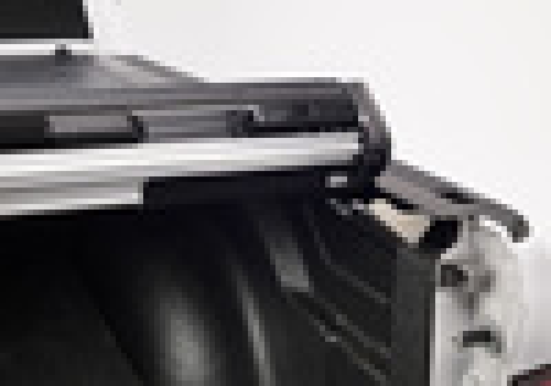 Black and white dog sitting on white surface - bak 19-20 dodge ram 1500 truck bed revolver x2