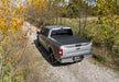 Dodge ram with ram box revolver x4s bed cover parked on dirt road in the woods