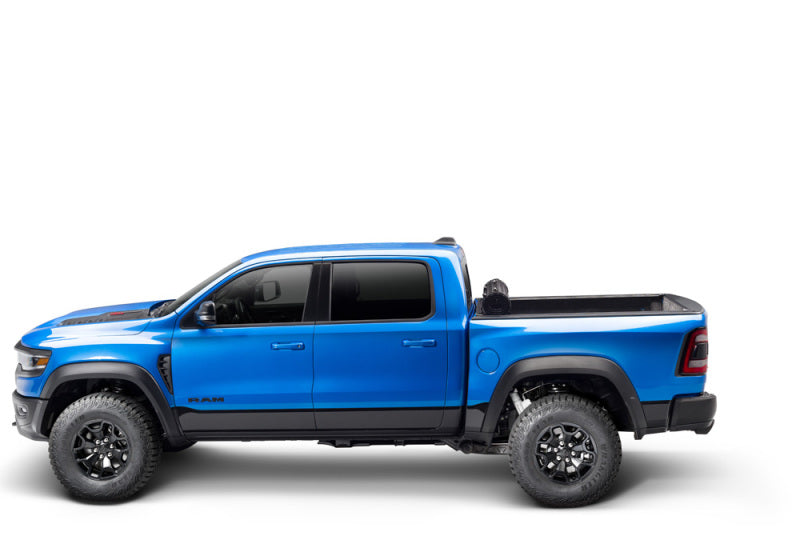 Blue truck bed cover for 19-21 dodge ram with revolver x4s on white background