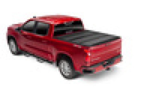 Red toy car on white background displayed with bak 19-21 gm sierra 1500 (carbon pro bed) 5ft 8in bed bak