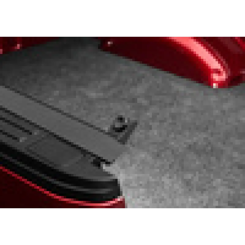 Red motorcycle with black brake pad on BAK Revolver X4s 5ft Bed Cover.