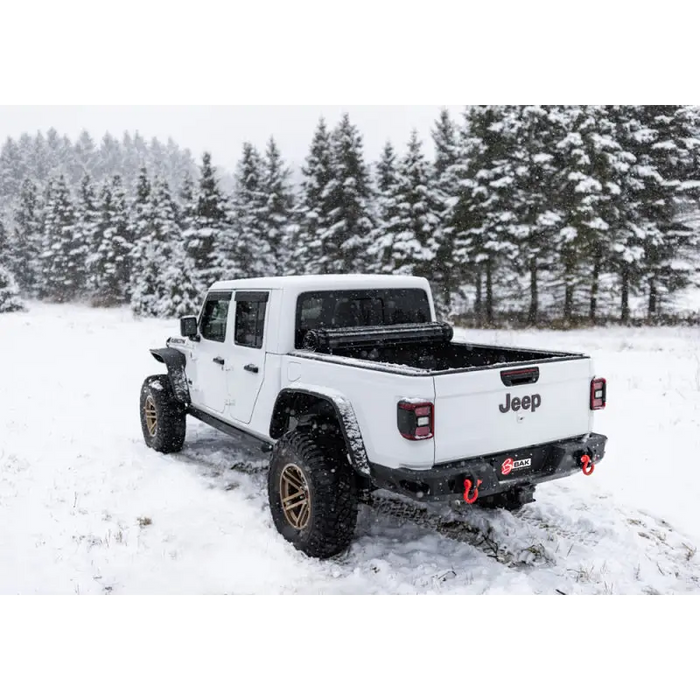 White truck driving through snow - BAK 20-21 Jeep Gladiator Revolver X4s Bed Cover