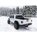 White truck driving through snow - BAK 20-21 Jeep Gladiator Revolver X4s Bed Cover