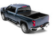 Toy truck with black top and red wheels displayed in bak 2020 chevy silverado 2500/3500 hd 6ft 9in bed b