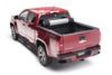 Red toy car on white background next to bak 2020 chevy silverado 2500/3500 hd 6ft 9in bed revolver x