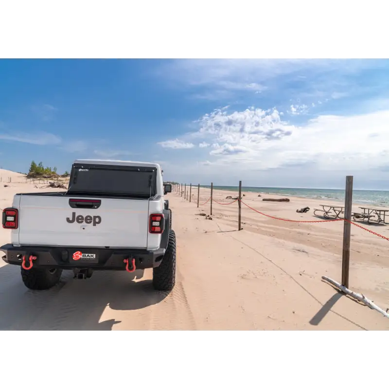White truck parked on beach - BAK 2020 Jeep Gladiator 5ft Bed BAKFlip MX4.