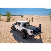 Man sitting on bed of BAK 2020 Jeep Gladiator 5ft Bed BAKFlip MX4.