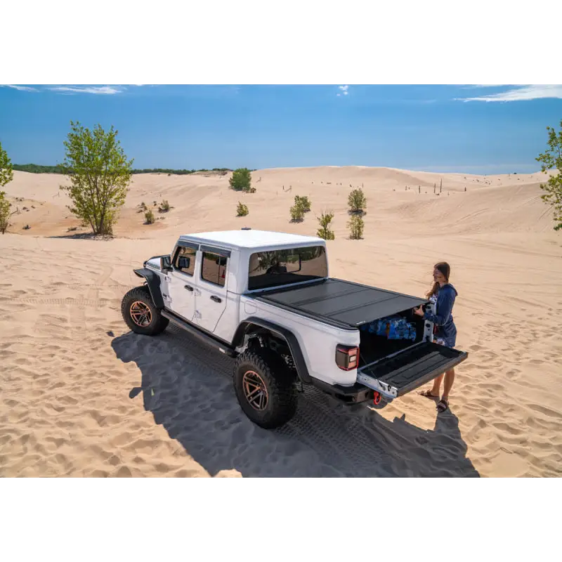 Man sitting on bed of BAK 2020 Jeep Gladiator 5ft Bed BAKFlip MX4.