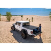 BAK 2020 Jeep Gladiator 5ft Bed BAKFlip MX4 with man standing next to truck in desert