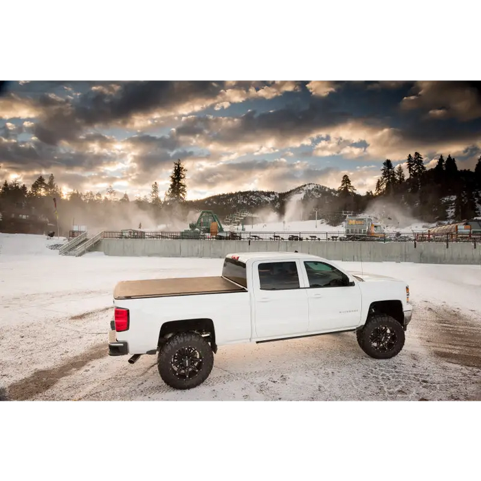 White truck parked in snow, BAK 2020 Jeep Gladiator 5ft Bed Revolver X2 alt text.