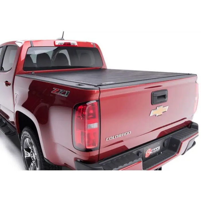 Red truck with black bed cover - BAK 2020 Jeep Gladiator 5ft Bed Revolver X2