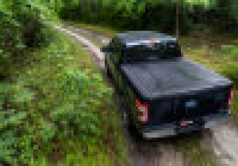 Ford f-150 revolver x4s truck bed cover driving down a dirt road