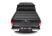 Rear view of black truck bed cover for 2022 nissan frontier - bakflip mx4