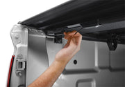 Man fixing door handle on van during bak 2022 nissan frontier 5ft bed bakflip mx4 matte finish installation
