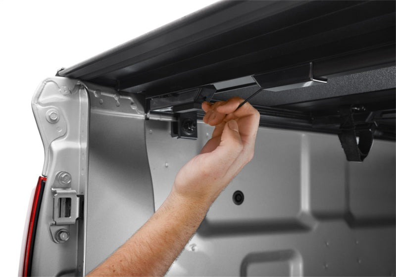 Man fixing door handle on van during bak 2022 nissan frontier 5ft bed bakflip mx4 matte finish installation