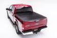 Red car with white background showcasing bakflip f1 5.7ft bed cover for ford f-150