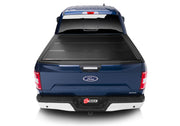 Blue truck with tail light on featuring bakflip g2 bed cover for 21-22 ford f-150