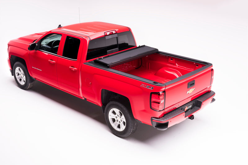 Red truck with black bed cover - bakflip mx4 for chevrolet silverado 1500 & gmc sierra 2500/3500 hd