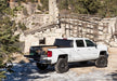 White chevrolet silverado parked in front of stone building - bakflip g2