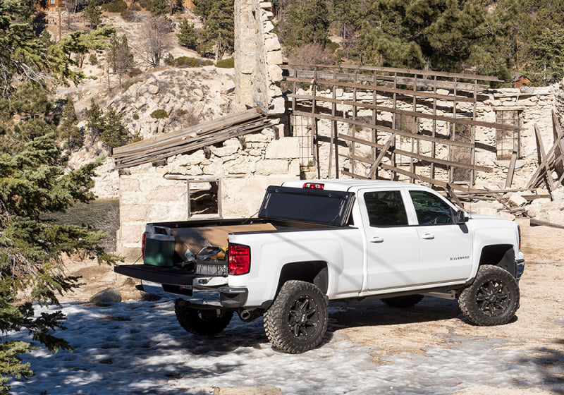 White chevrolet silverado parked in front of stone building - bakflip g2