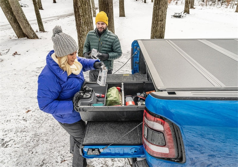 Couple loading cooler into truck bed with bakflip mx4 installation kit