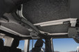 Interior of a jeep wrangler with sunroof and sunroad displayed, showcasing bedrug headliner