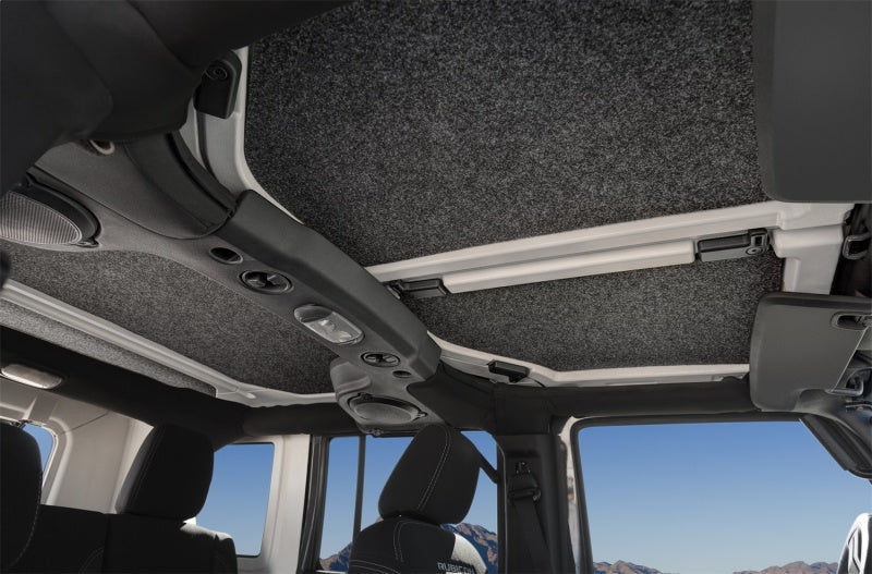 Interior of a jeep wrangler with sunroof and sunroad displayed, showcasing bedrug headliner