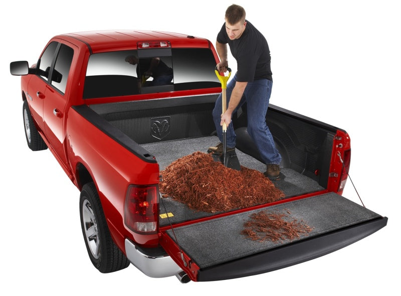 Man loading wood chips into ford f-150 truck bed