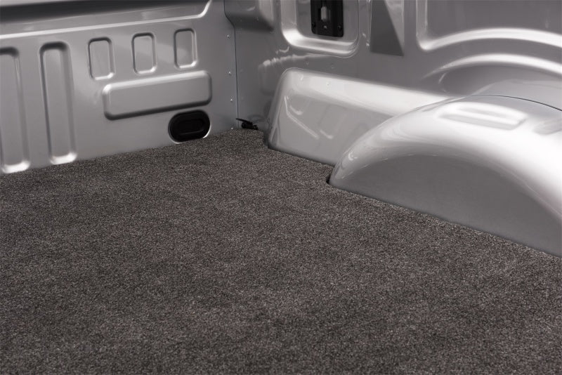 Interior of white truck with gray carpet showcasing bedrug 6ft9in bed mat for gmfs hd model