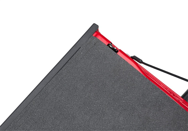 Red and black triangle-shaped impact mat for jeep gladiator truck bed