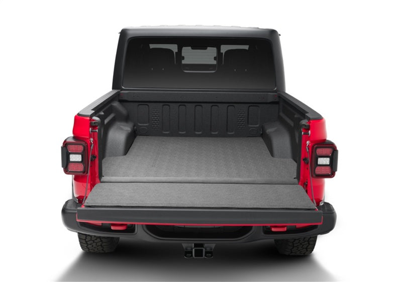 Red jeep gladiator 5ft truck bed mat with open trunk - bedrug impact mat for jeep wrangler