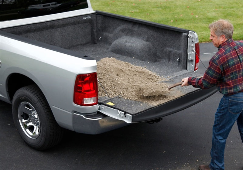 Man loading a truck with a shovel - bedrug 2019+ dodge ram 5.7ft bed bedliner