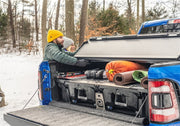 Man loading tools into bedrug bedliner for 2019+ dodge ram without multi-function tailgate
