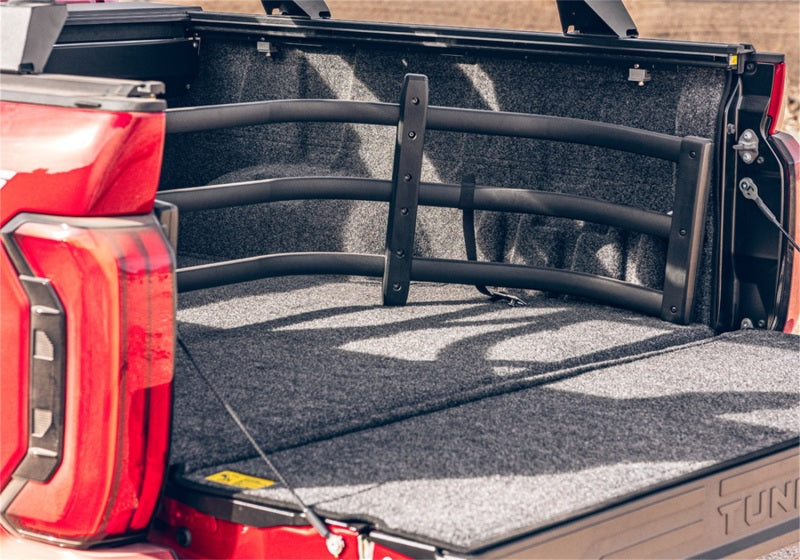Red jeep wrangler trunk compartment showcasing bedrug bedliner for toyota tundra