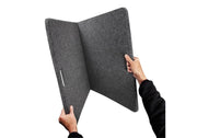 Person holding bedrug 2ft x 4ft folding utility mat trackmat on white background