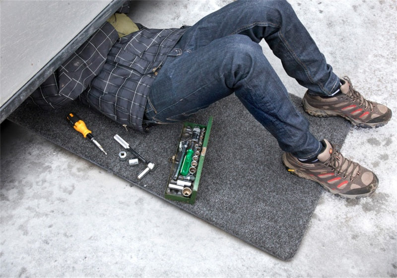 Man using utility mat near jeep wrangler