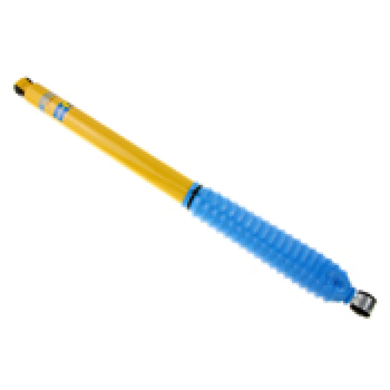 Blue and yellow plastic ballpoint pen displayed in bilstein b6 shock absorber product
