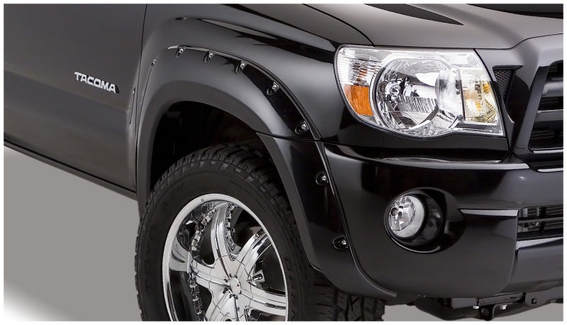 Black truck with chrome rim, toyota tacoma fender flares - bushwacker pocket style 4pc bed