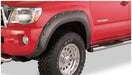 Red truck with black and white bumpers featuring bushwacker toyota tacoma pocket style fender flares