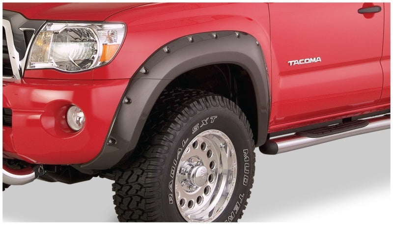 Red truck with black and white bumpers featuring bushwacker toyota tacoma pocket style fender flares