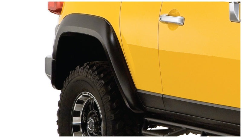 Yellow truck with black tire cover - bushwacker extend-a-fender style flares for toyota fj cruiser