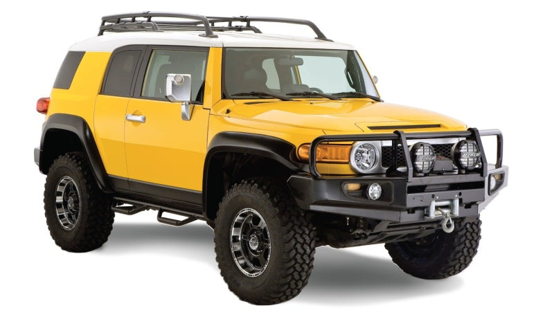 Yellow toyota fj cruiser with black roof rack - bushwacker extend-a-fender style flares