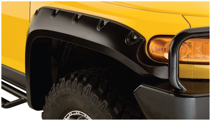 Yellow toyota fj cruiser with black pocket style fender flares