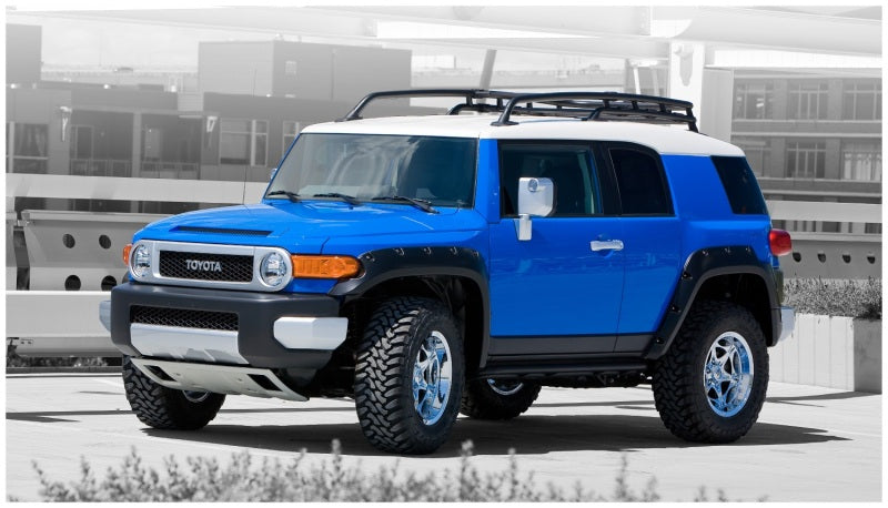 Blue and white toyota fj cruiser with pocket style fender flares by bushwacker