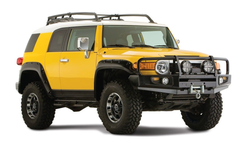 Yellow toyota fj cruiser with black pocket style fender flares