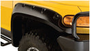 Close up image of yellow toyota fj cruiser with black bumper and pocket style flares