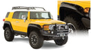 Yellow toyota fj cruiser with black bumper and pocket style fender flares