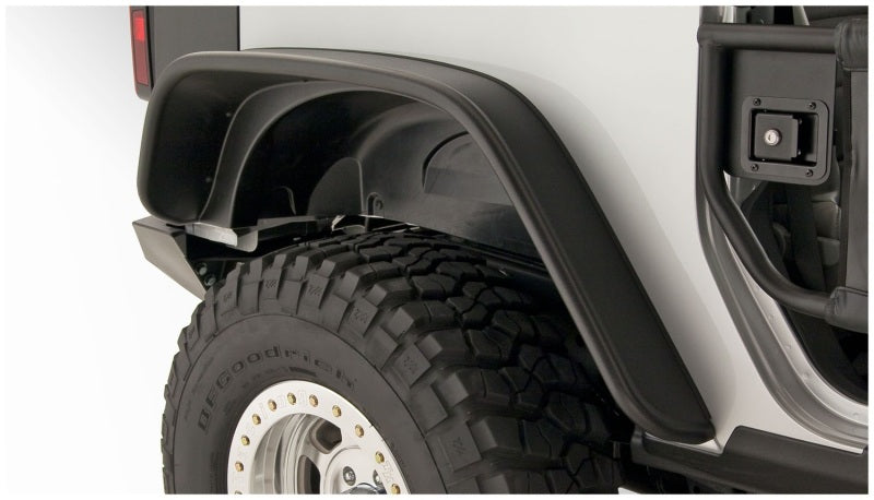 Close up of a truck with flat style fender flares and tire guard - bushwacker 07-18 jeep wrangler in black
