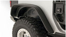 Close up of bushwacker flat style fender flares on a jeep wrangler truck with tire guard