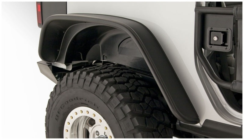 Close up of bushwacker flat style fender flares on a jeep wrangler truck with tire guard